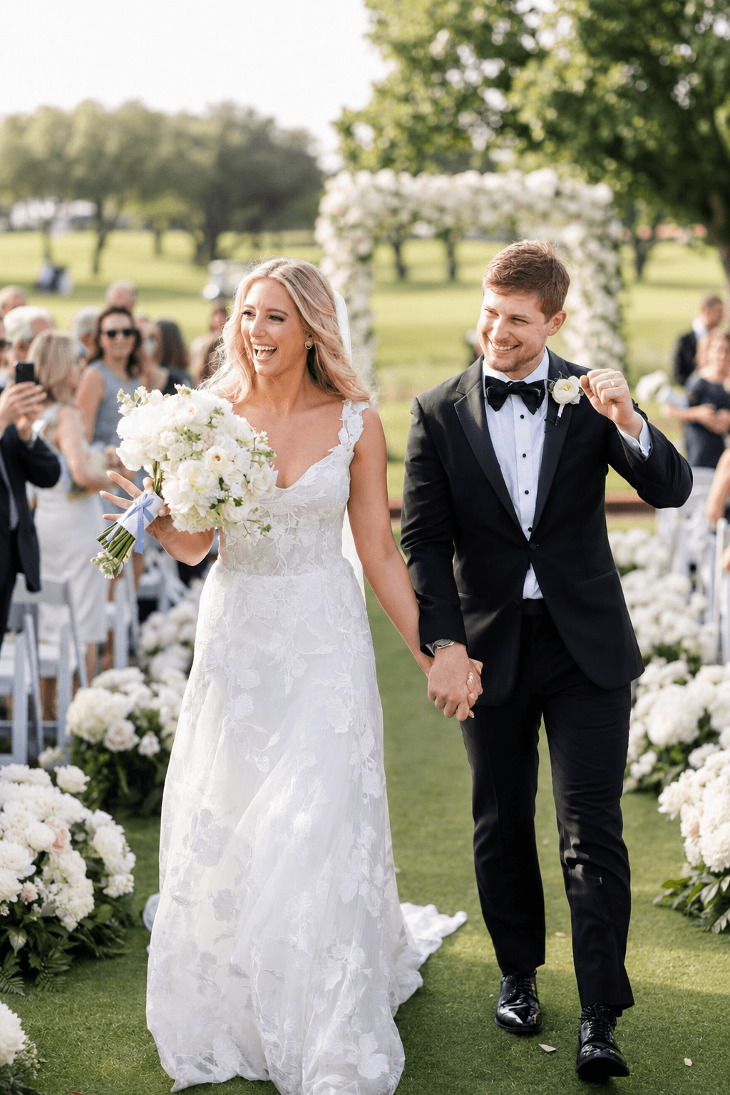 Bride and groom joyful recessional in outdoor sunlight